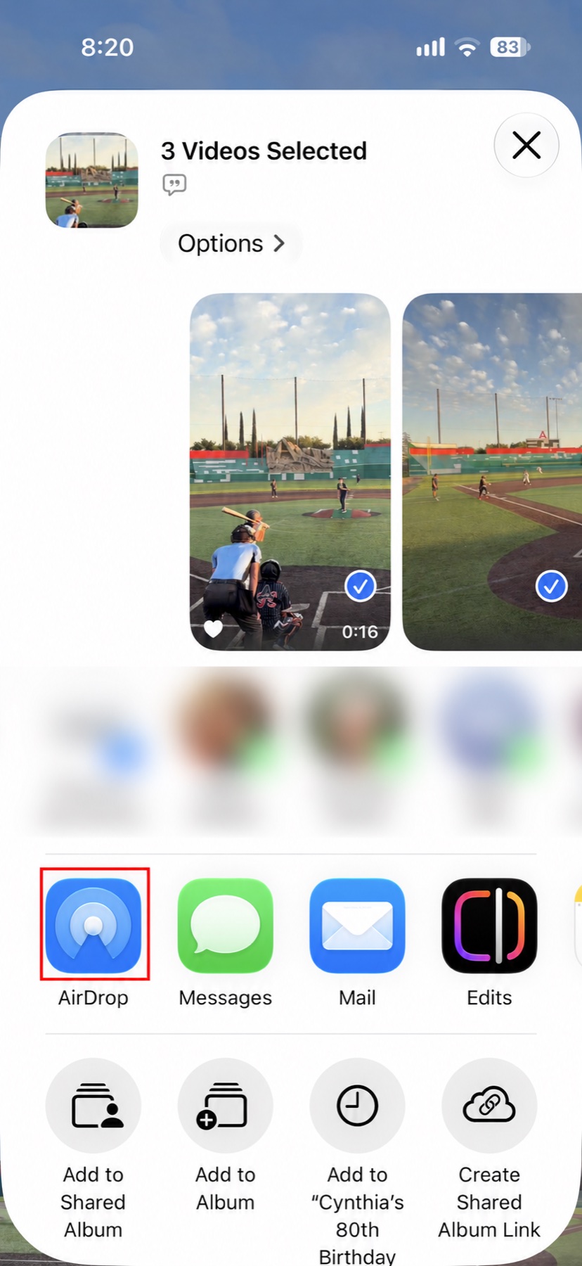 iOS share sheet with AirDrop outlined in red and suggested recipients blurred